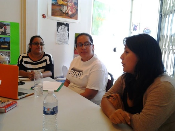 Street Level Health Project's Gabriela Galicia, left, and Laura López, far right, speak to the Wage Fairness project about their organization and listen to our policy proposals on August 15.